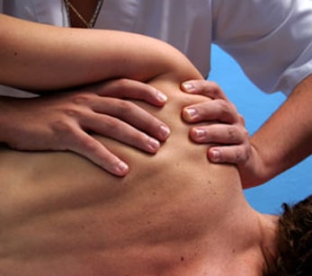 Sports massage technique on a shoulder 